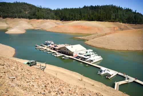 California's drought exposes the 180-200-foot drop in water levels at the Silverthorn Resort. The reservoir is receding at an average of 4.9 inches per day.