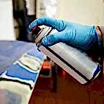 hand with spray paint can