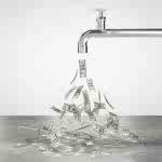 dollar bills coming out of metal faucet