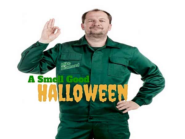 plumber in green uniform with "Mike Diamond" logo on right pocket making "three-oh" sign