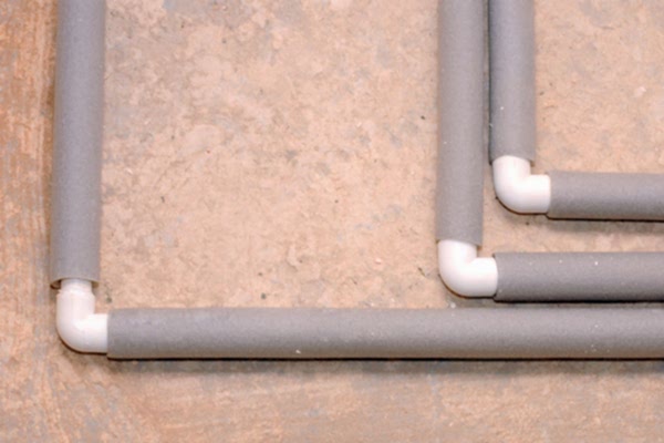 Pipes wrapped in grey insulation