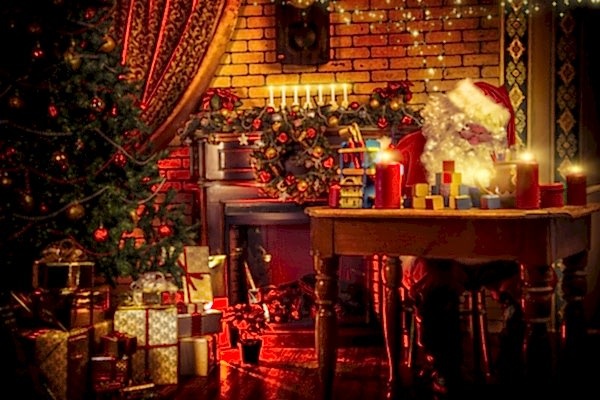 Santa sitting at table with head down. Table covered in candles and toys. Fireplace behind Santa, Christmas tree to his left. Presents beneath tree.