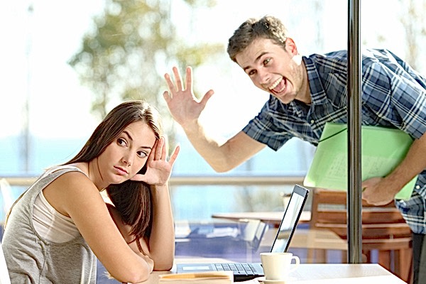 annoying guy waving at woman, who is clearly attempting not to make eye contact