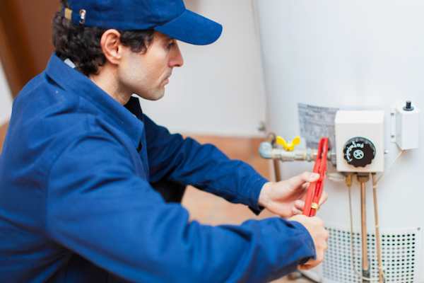 plumbing technician installing a water heater