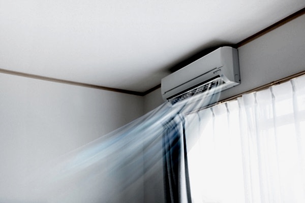 Wall air conditioner unit blowing cool air into home