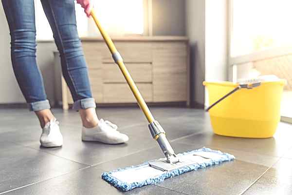 Homeowner mopping linoleum floor
