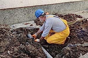 Expert plumber fixing a sewer line