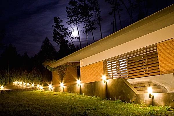Yard lights in front of house at night