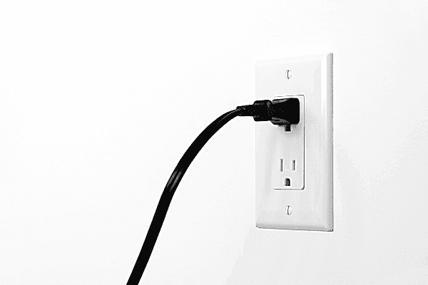 Electrical cord plugged into a wall outlet