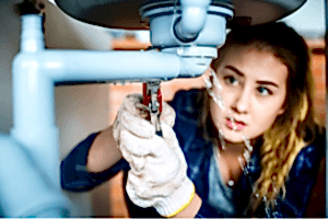 woman struggling with a leaking pipe