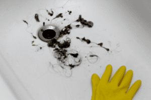 Hair clogs removed from a bathroom sink drain.