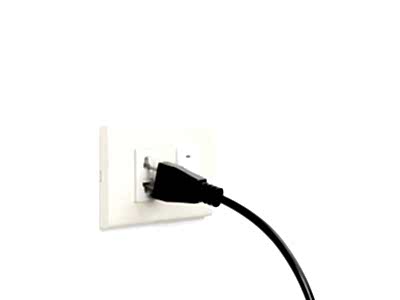 A loose plug slips out of an electrical outlet.