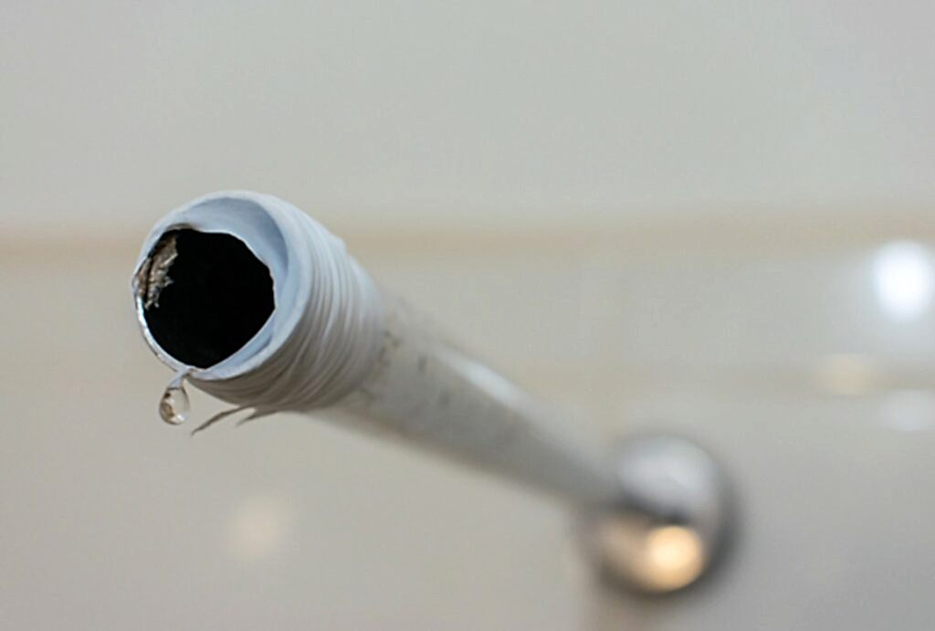 A shower arm with Teflon tape wrapped around it. Ready for new showerhead.