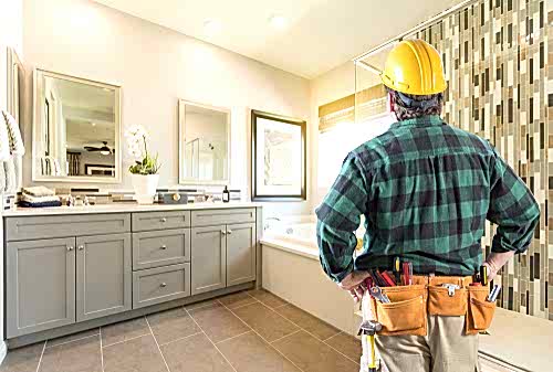 A plumber surveys a bathroom after a remodel projects.